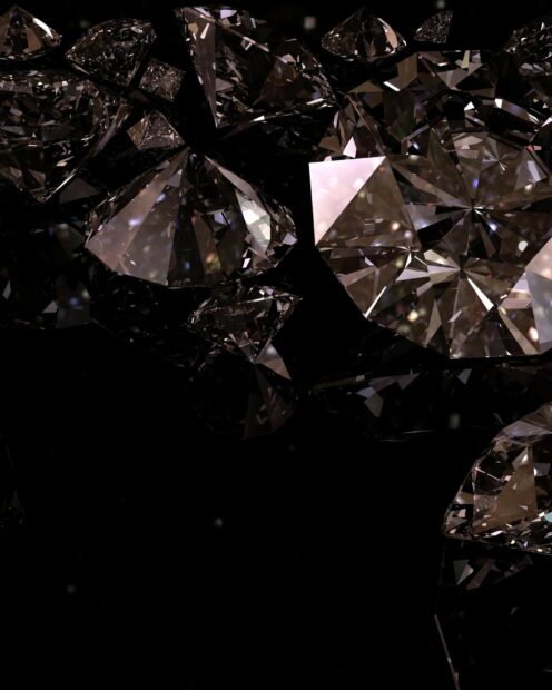 Shiny gemstone pieces reflecting light on a dark background