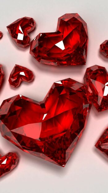 Shining red gemstone hearts scattered on a smooth surface