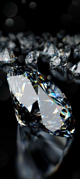 Close up of a gemstone sparkling with prism light reflections on a dark surface