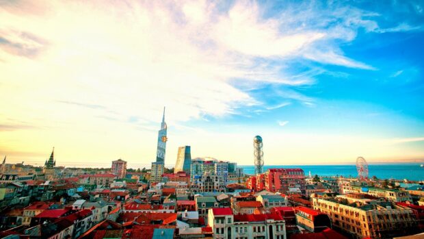 The cityscape of Georgia with vibrant rooftops and modern towers under a bright sky
