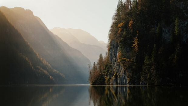 Calm lake reflecting mountains and autumn trees in Germany nature