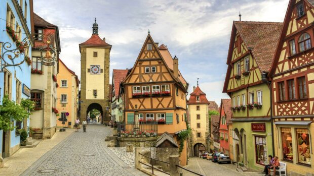 Historic Germany street with timber framed houses and clock tower in a medieval town