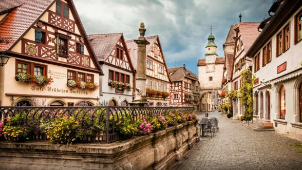 Traditional German street with colorful flowers and historic half timbered buildings in Germany