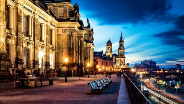 Historic architecture along the river in Germany at dusk with glowing street lamps