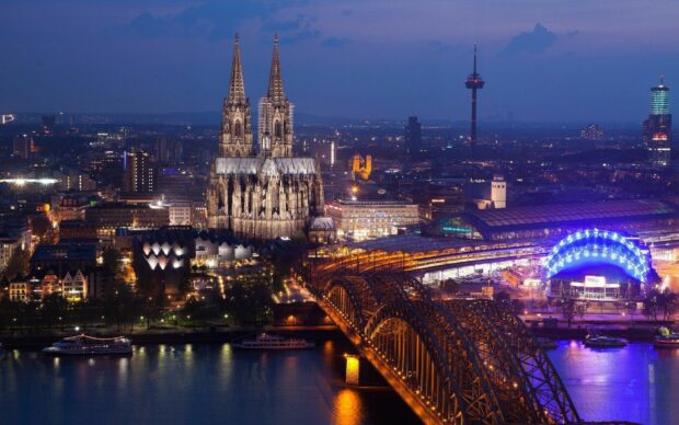 Night cityscape of Germany featuring Cologne Cathedral and Hohenzollern Bridge