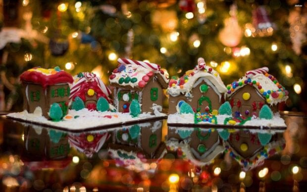 Colorful gingerbread houses decorated with candy and icing in a festive setting