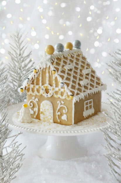 Gingerbread House Wallpapers 2K Mobile Beautiful gingerbread house decorated with white icing and golden accents on a snowy stand