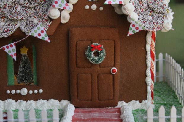 Detailed gingerbread house door with a wreath and festive decoration