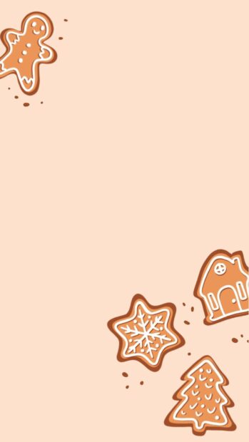 Gingerbread house and festive cookies arranged on a plain background
