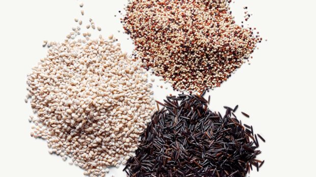 Close up of grains in different varieties on a white surface with grains