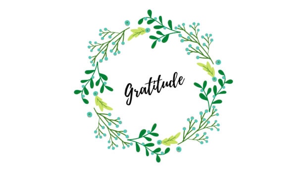 A decorative wreath with green leaves and berries surrounding the word gratitude in elegant script