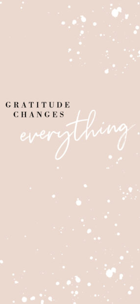 Gratitude changes everything quote on a beige background with white paint splatters