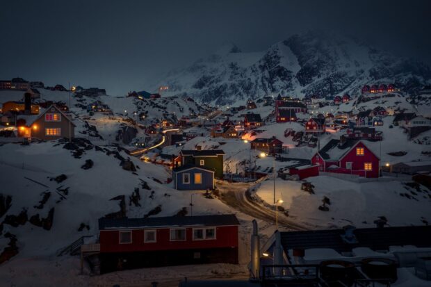 Greenland Wallpapers HD Desktop Greenland village covered in snow under a dark sky with mountain in the background