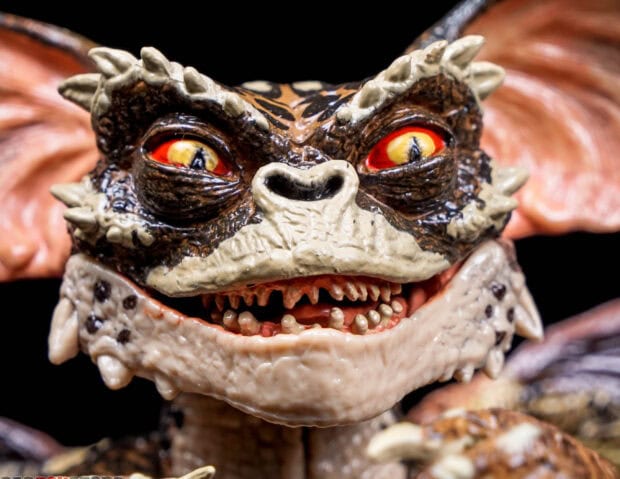 Close up of a gremlin figurine showing detailed face and sharp teeth