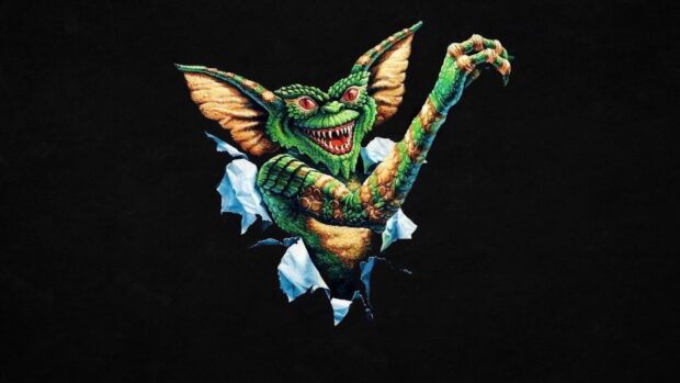 A green gremlin bursting through torn paper with sharp teeth and claws