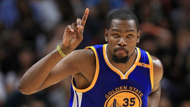 Basketball player wearing number 35 Golden State Warriors jersey pointing finger upward