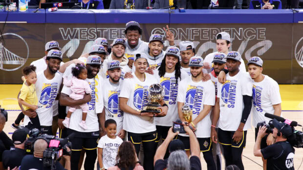Golden State Warriors team celebrating winning the Western Conference championship trophy