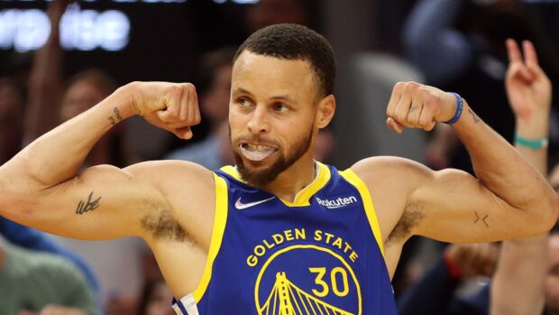 Stephen Curry in Golden State uniform showing strength during a basketball game