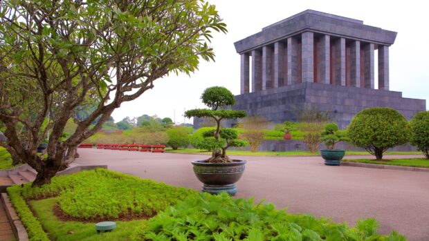 The monument surrounded by green trees and plants in Hanoi garden