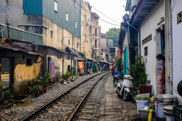 Old residential street with railway tracks in Hanoi city