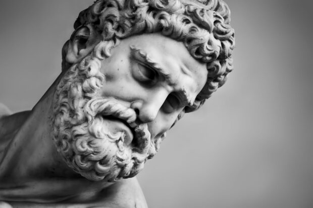 Close up of Hercules statue with detailed curly hair and beard