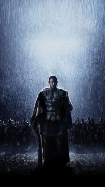 Hercules standing in rain with soldiers behind him holding a sword