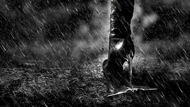 Black high heels standing in the rain on a wet surface with splashing water