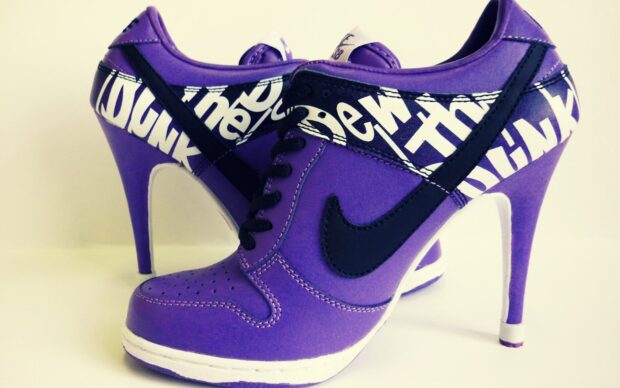 Purple high heels with black accents and white graphic design on the sides
