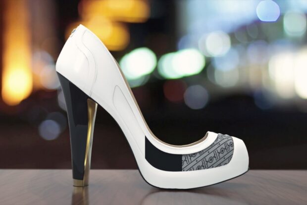 White high heels with patterned details placed on a surface in an urban night setting