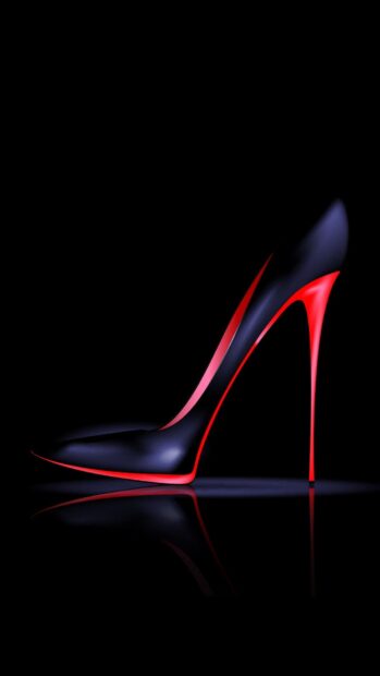 Sleek black and red high heels with a tall stiletto heel on a reflective surface