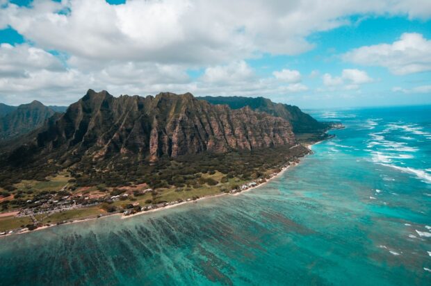 A scenic view of Honolulu mountains and coastline under a cloudy sky