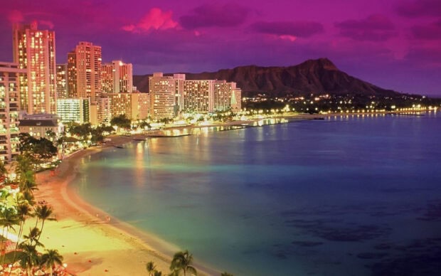 Honolulu city skyline with purple sky and Diamond Head mountain in the background