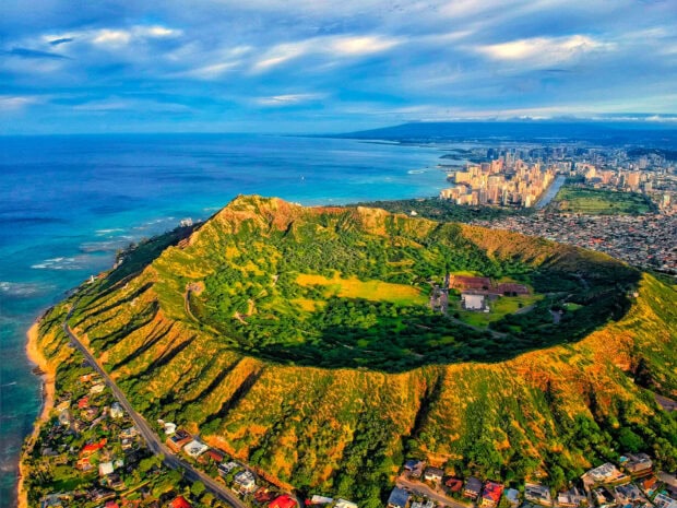 Aerial view of Honolulu volcanic crater and cityscape with ocean in the background