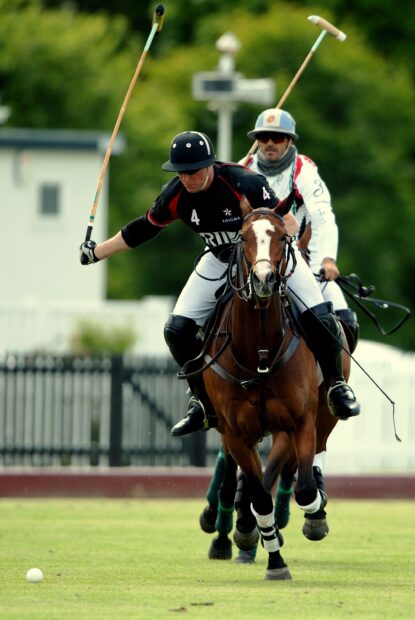 Polo player riding a horse during a horse polo match on the field
