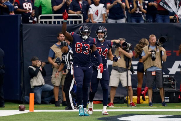 Houston Texans players celebrating a touchdown on the field during a game
