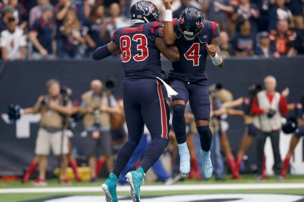 Houston Texans players celebrating a touchdown on the football field in action