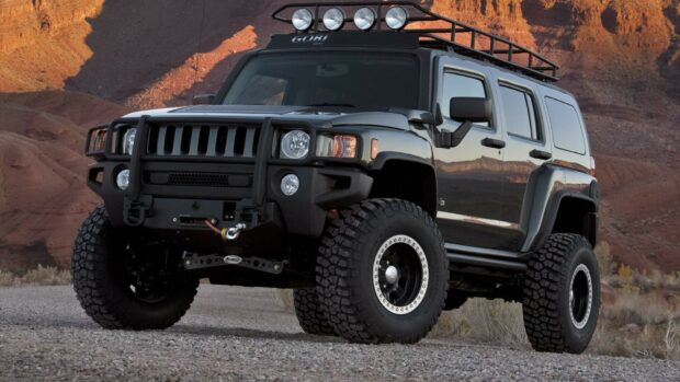 A rugged Hummer vehicle equipped for off road driving in a desert landscape