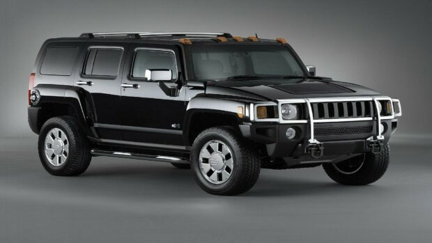 Black Hummer SUV with chrome wheels and protective bars