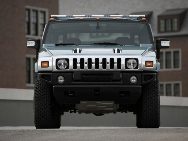 Front view of a Hummer vehicle with its iconic grille in an urban setting
