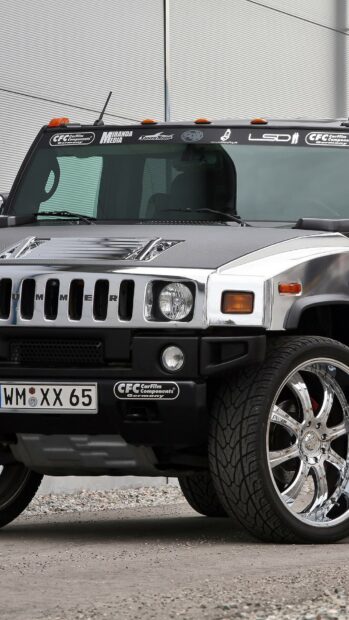 Front view of Hummer with shiny chrome wheels on a gravel surface
