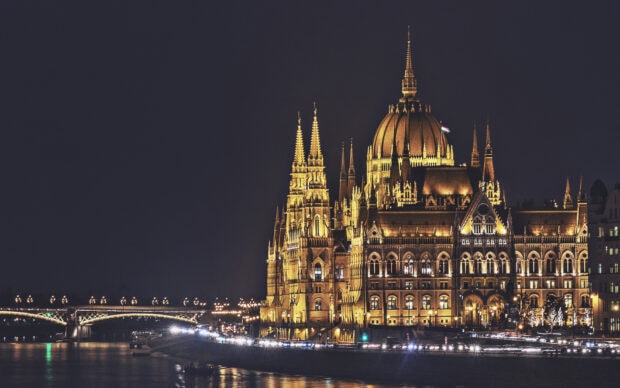 The illuminated parliament building is a famous landmark in Hungary at night