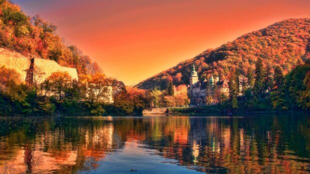 Autumn trees near lake in Hungary reflecting on water surface