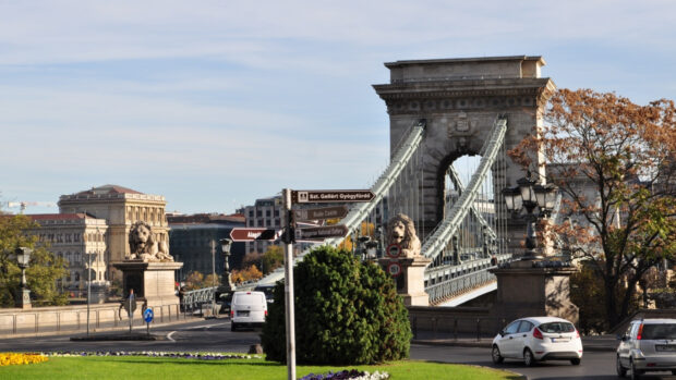 Historic Budapest cityscape with lion statues and chain bridge on a sunny day