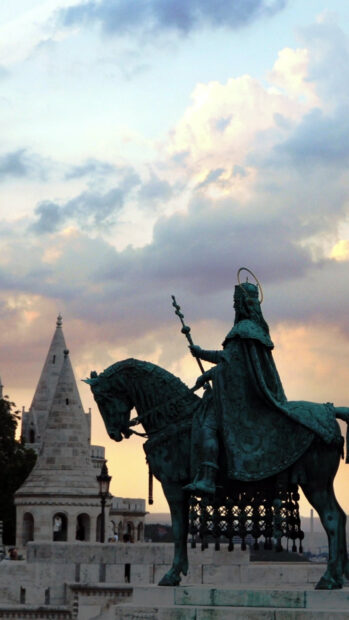 Bronze statue of a Hungarian king on horseback at Fisherman's Bastion during sunset