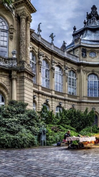 Historic building with statues and greenery in Hungary courtyard