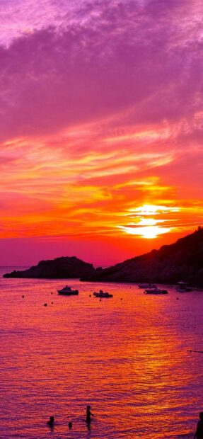 Beautiful Ibiza sunset with colorful sky and calm sea during evening time
