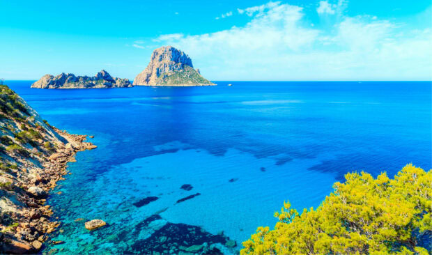 Clear blue sea and rocky coast with Ibiza island landscape in summer