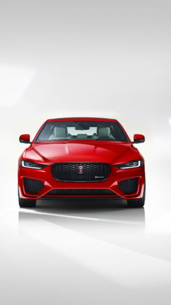 Red Jaguar car front view in a studio setting with sharp design details