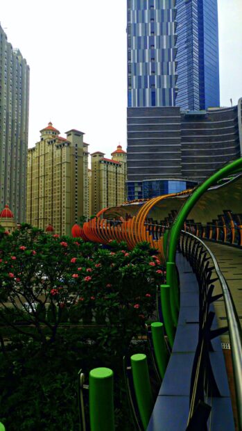 Modern Jakarta architecture with colorful pedestrian bridge and high rise buildings in Jakarta