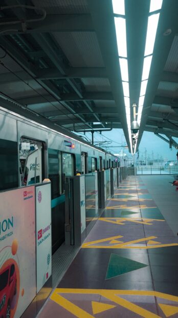 Modern train station platform in Jakarta with safety barriers and geometric floor patterns